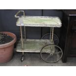 A 1960s two tiered brass drinks trolley,