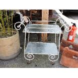 A white painted wrought iron trolley wit
