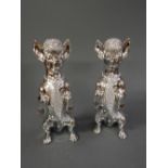A pair of silvered metal models of dogs