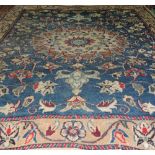 An antique Isfahan rug the central floral medallion on blue ground with palmette design and camel
