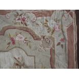 An Aubusson design carpet, the all over floral design on olive ground within corresponding border,