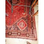 An antique Persian Qashqai carpet, the central medallion on rouge ground with motif decoration,