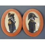 A pair of oval silhouette print portraits of naval officers