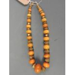 SOLD IN TIMED AUCTION An Amber and metal necklace