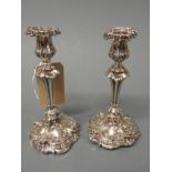 A pair of 19th century silver Roccoco style filled candlesticks