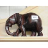 A carved wooden elephant sculpture (A/F lacking tusk)