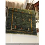 A Gabbeh rug, the all over figural decoration within gold band on an abrashed aquamarine ground,