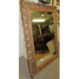A 20th Century carved walnut wall mirror,