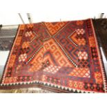 A large Anatolian Kilim carpet, the all over blue and orange geometric design on rouge ground,