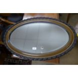 An oval wall mirror,