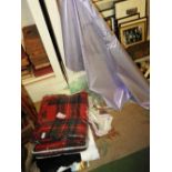 A roll of lilac coloured material, two tartan car rugs,