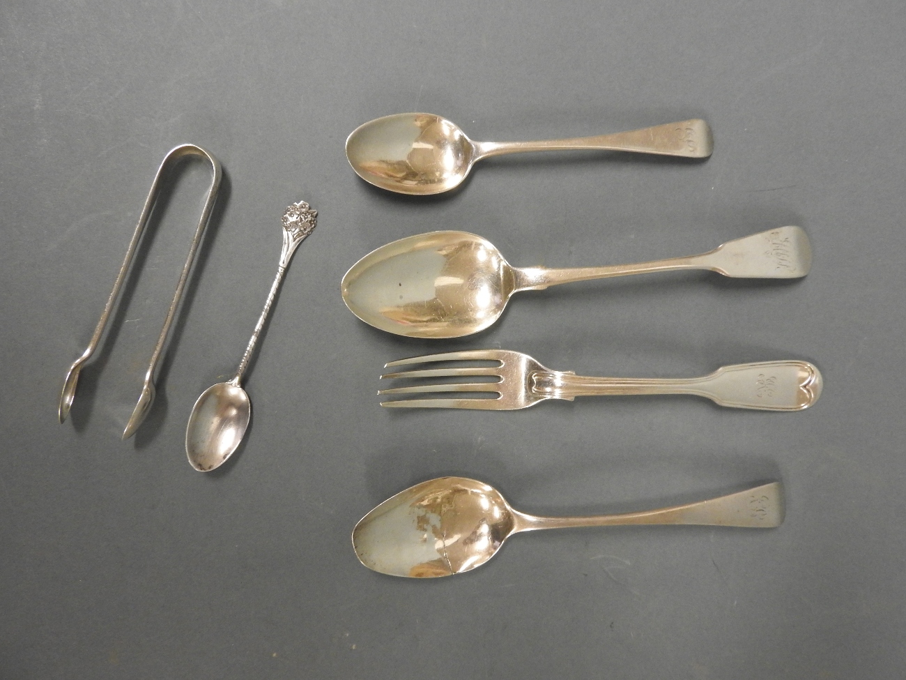A mixed collection of mainly Georgian silver desert and tea spoons along with a Victorian fork,
