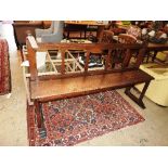 A French oak hall bench with carved fini