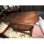 An oak drop leaf table, 1930s