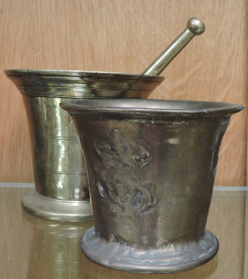 A solid brass pestle and mortar, and ano