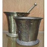 A solid brass pestle and mortar, and ano