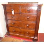 A 19th Century mahogany chest fitted two short and three long drawers flanked by carved corbels