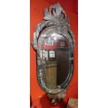 A Venetian style wall mirror with ornate crest,