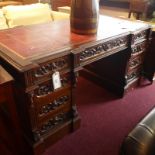 A 19th Century profusely carved mahogany pedestal desk,