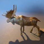A brass figure of a Moose.