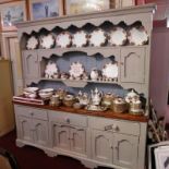 A 19th Century painted and pine country dresser having open plate racks above three frieze drawers