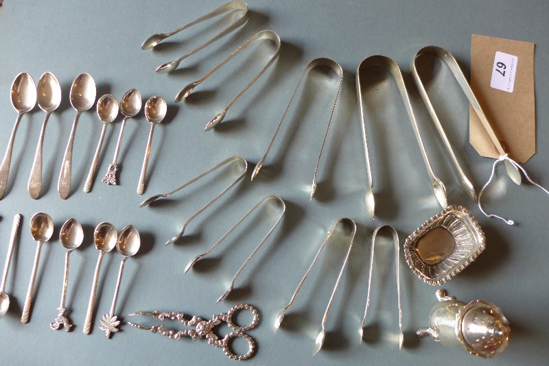 A collection of hallmarked silver items including sugar tongs and coffee spoones