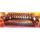 A 20th Century Chesterfield three seater sofa upholstered in black buttoned and studded leather and