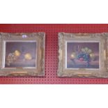 A pair of oils on board by JF Smith, still life studies of fruit on a table,