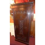 A 19th Century carved oak hall robe with angular cornice and single door enclosing hanging space on