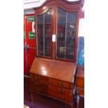 An Edwardian mahogany bureau bookcase fitted arched pair of glazed panel doors above fall front and
