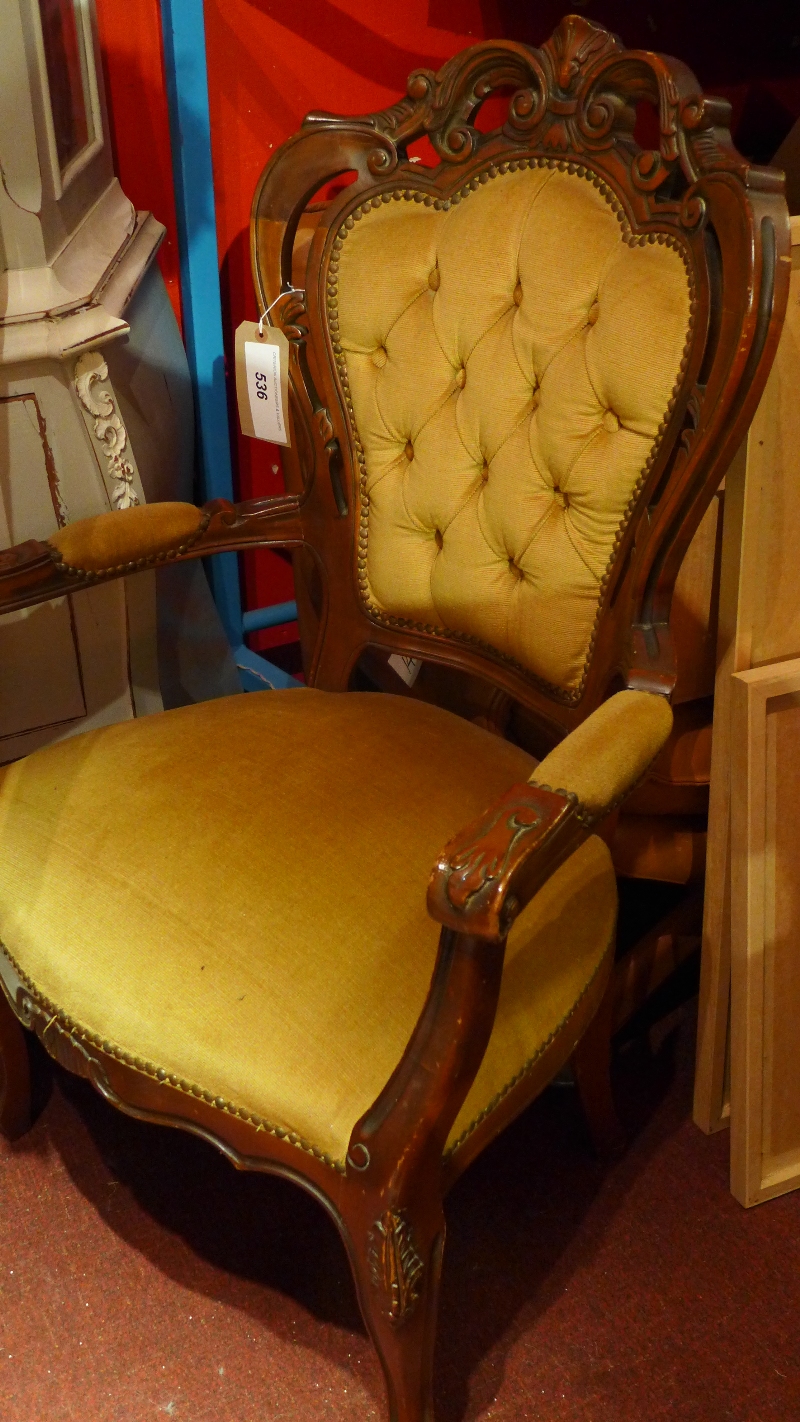 A French walnut armchair upholstered in green velour fabric and raised on cabriole supports.