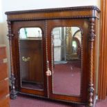 A Victorian walnut chiffonier having beaded detail and pair of mirrored panel doors flanked by