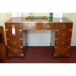 A 20th century campaign design mahogany and brass bound pedestal desk,