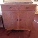 A Heals style 1930's limed oak side cabinet fitted two drawers and pair of panel doors on square