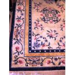 An antique Chinese rug, the all over foliate and palmette design on camel ground,