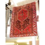 A Caucassian rug, the central medallion on red and brown ground within sky blue border,