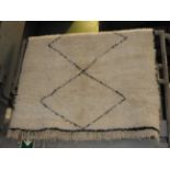 A Moroccan Berber rug with all over geometric tribal design,
