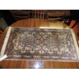 A small hard knotted Qum design silk rug,