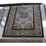 An Antique Chinese silk rug, the cream ground with foliate decoration,