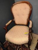 A late 19th Century Victorian mahogany open armchair,