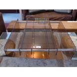 An unusual retro translucent brown plastic coffee table with adjustable sections and raised on