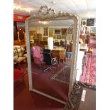 A 19th Century French carved and painted overmantel mirror with ribbon crest and beaded detail to