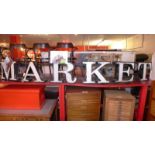 A large sign metal salvaged from Camden Market - 'Market' of bowed outline, 14.2 foot wide.