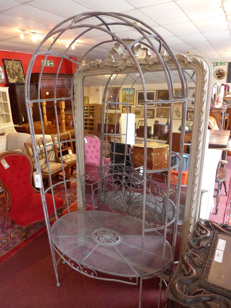 A wrought iron rose arch and garden seat