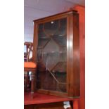 An Edwardian mahogany corner cabinet wit