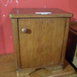 An Art Deco oak bedside cabinet fitted s