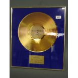 A framed and glazed gold coloured vinyl