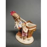 A porcelain figurine of a lady, child an