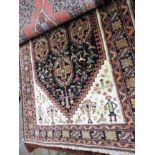 An antique Baktari carpet, the allover garden design on autumnal ground within corresponding border.