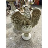 A pair of reconstituted stone eagles on ball plinth bases (2)